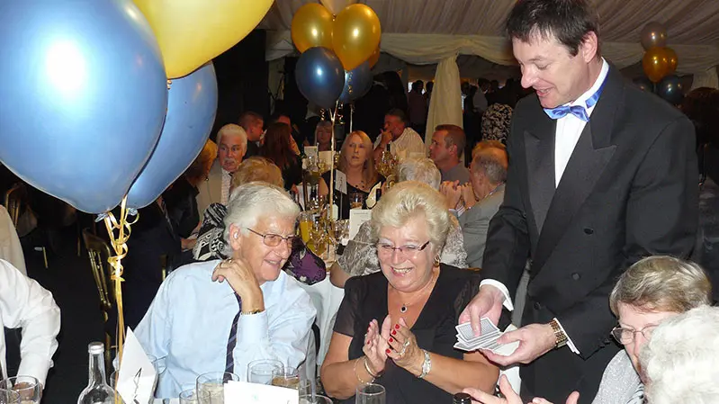 Corporate event with guests enjoying close-up magic