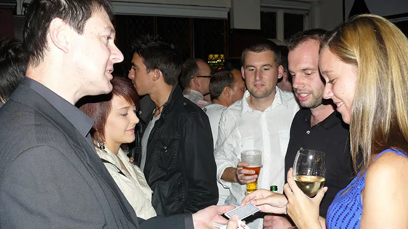 Party guests reacting to close-up magic